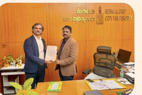 Santosh Talaghatti signing a Memorandum of Understanding with Bengaluru City University