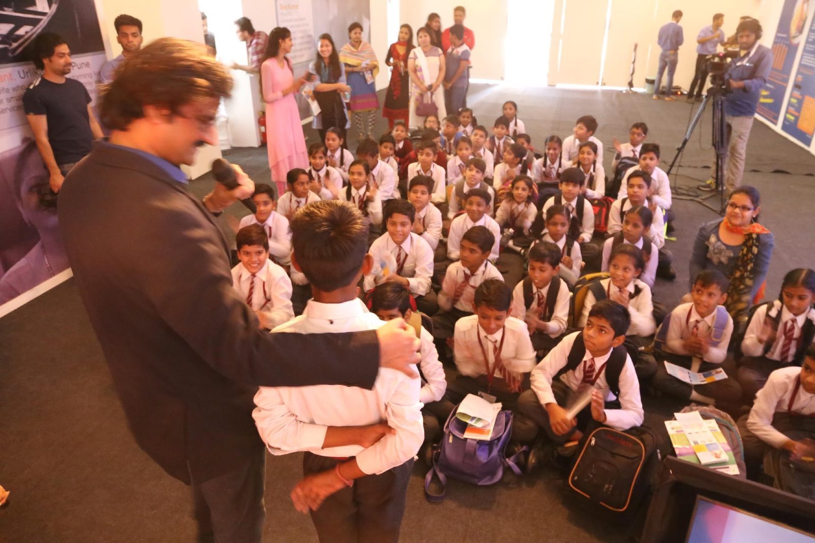Santosh Talaghatti warmly greeting a student during a rural school outreach visit